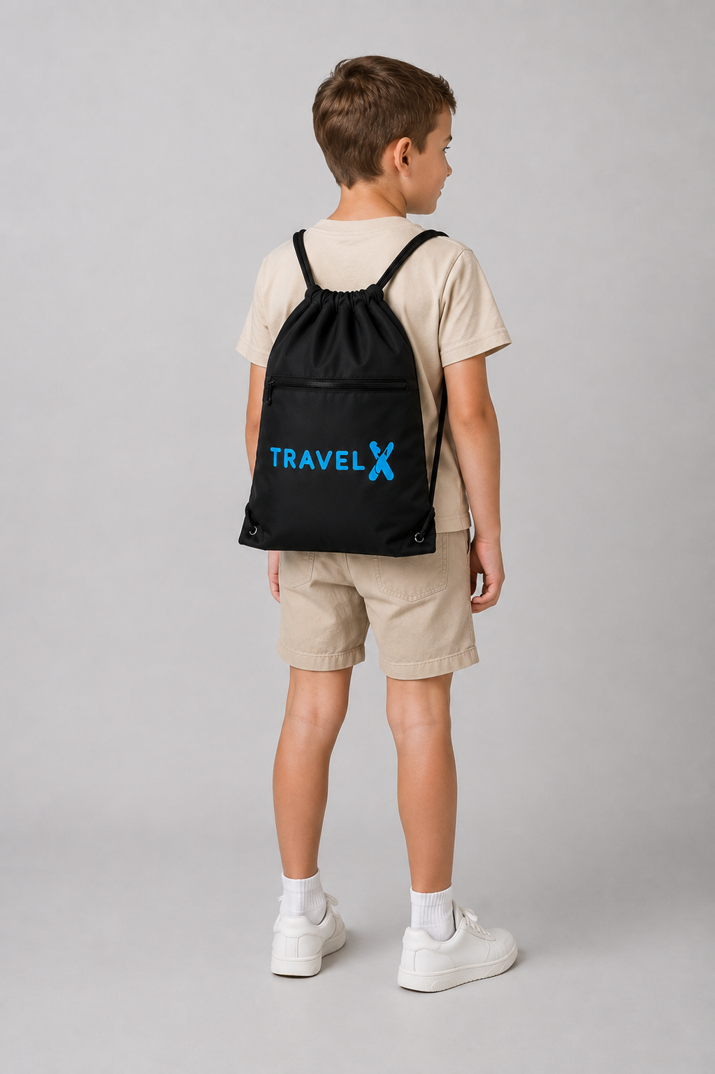 Boy wearing a Travel X Go Bag with blue logo